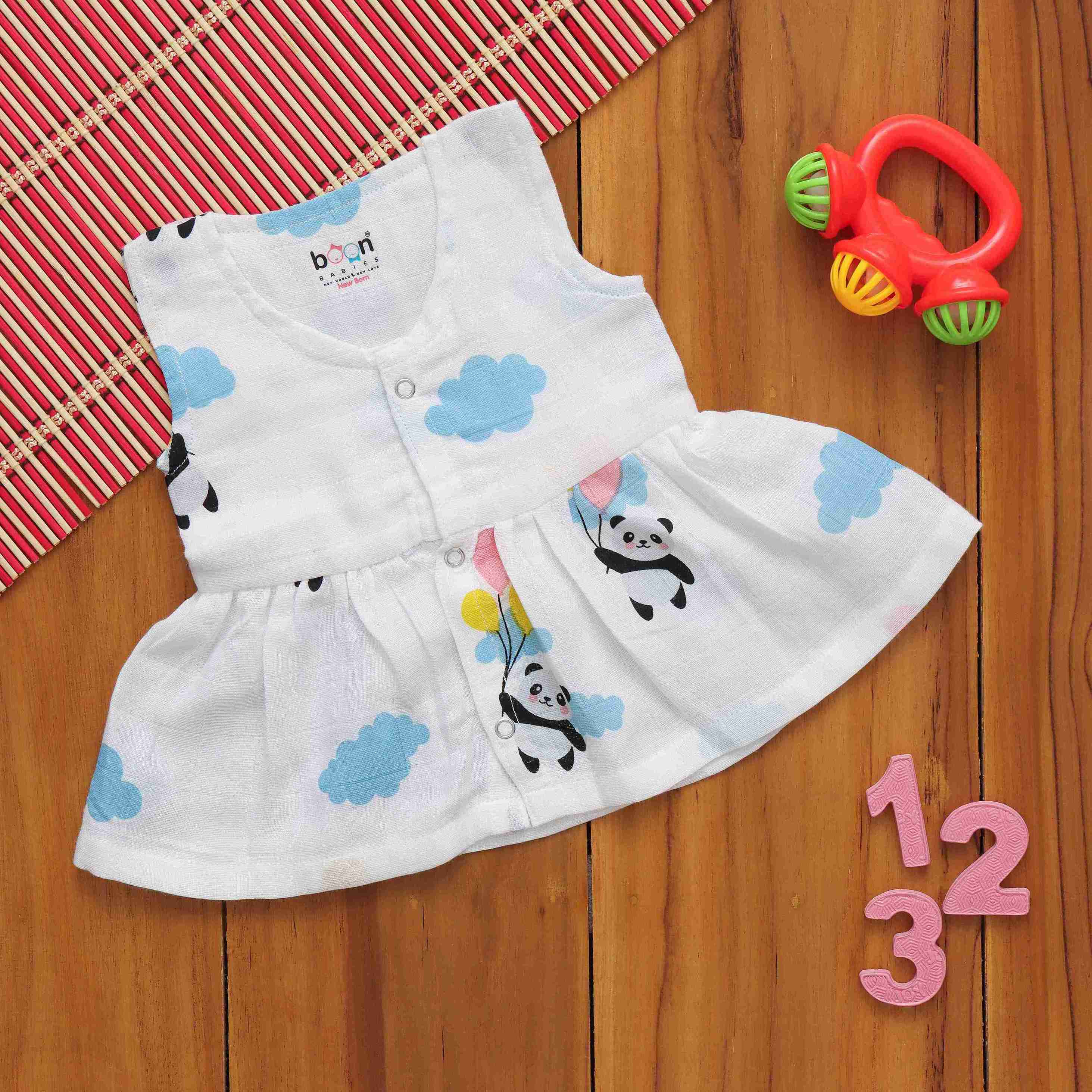 Baby girl in a charming Panda printed sleeveless frilled muslin frock by Boon Babies, showcasing playful elegance and soft fabric.