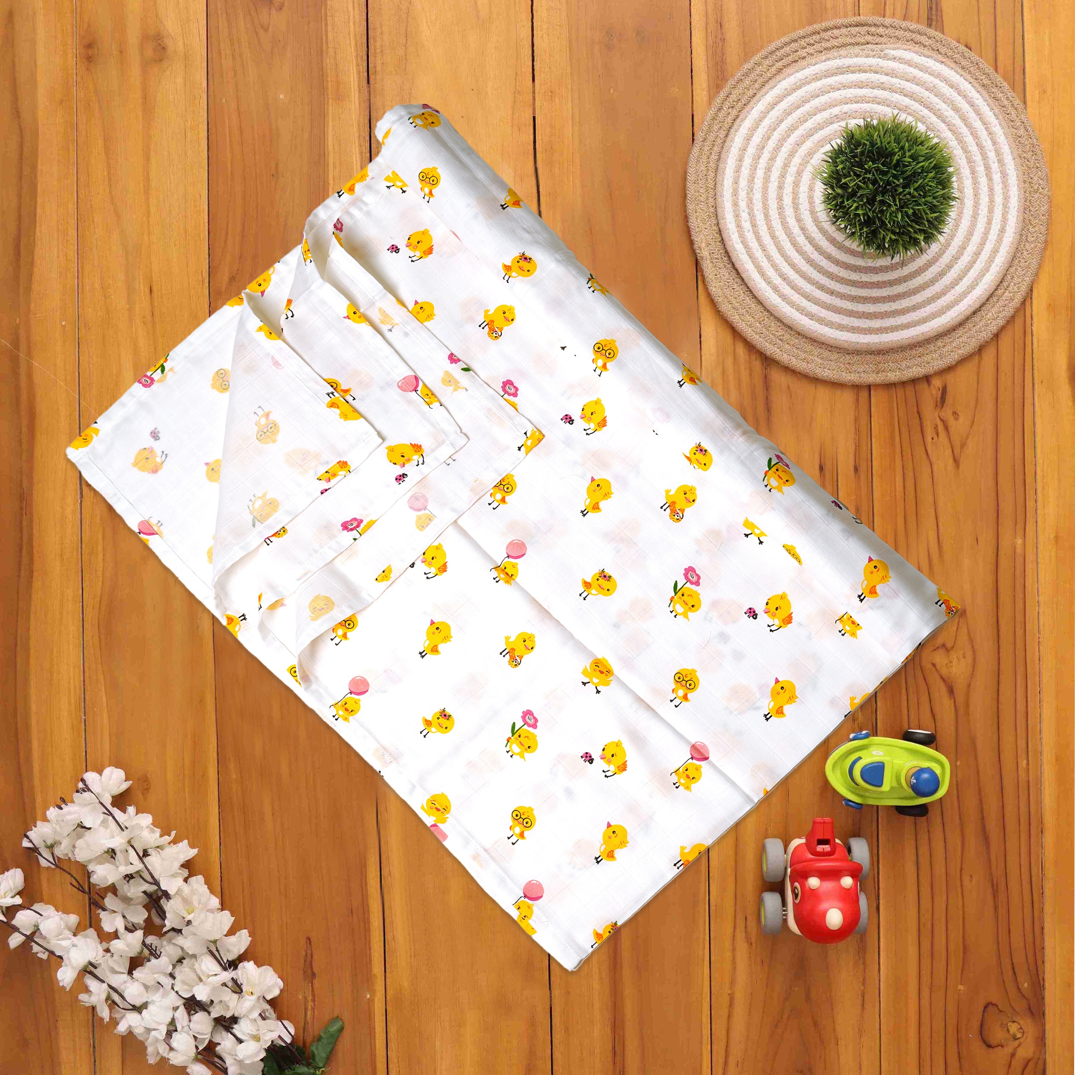 Boon Babies printed muslin baby swaddle with charming duckling print, soft and lightweight for comfortable wrapping.