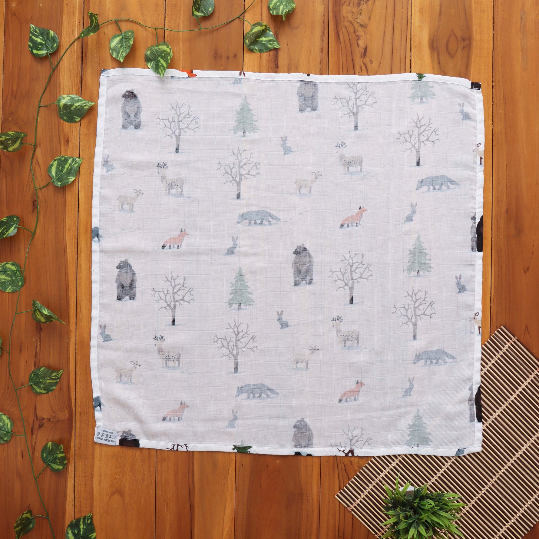 Nature-themed baby towel in soft muslin. Lightweight and gentle for newborn care.