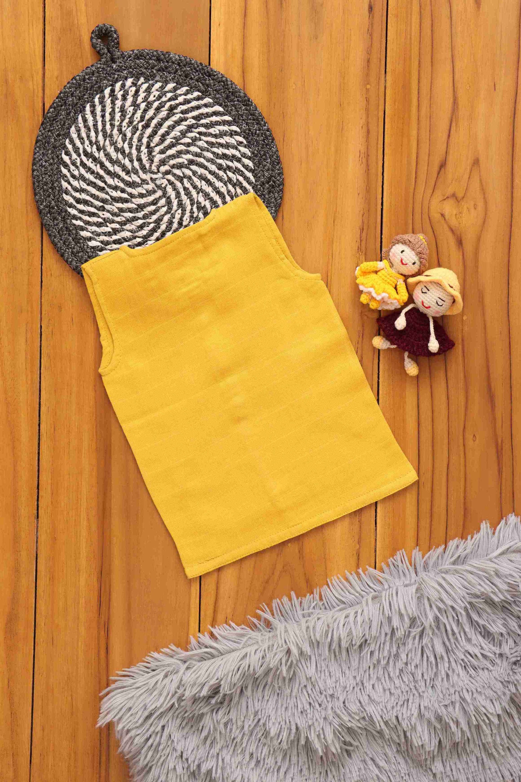 Organic muslin baby vest in mustard yellow, soft and eco-friendly solid jabla by Boon Babies, with four-layer breathable fabric.