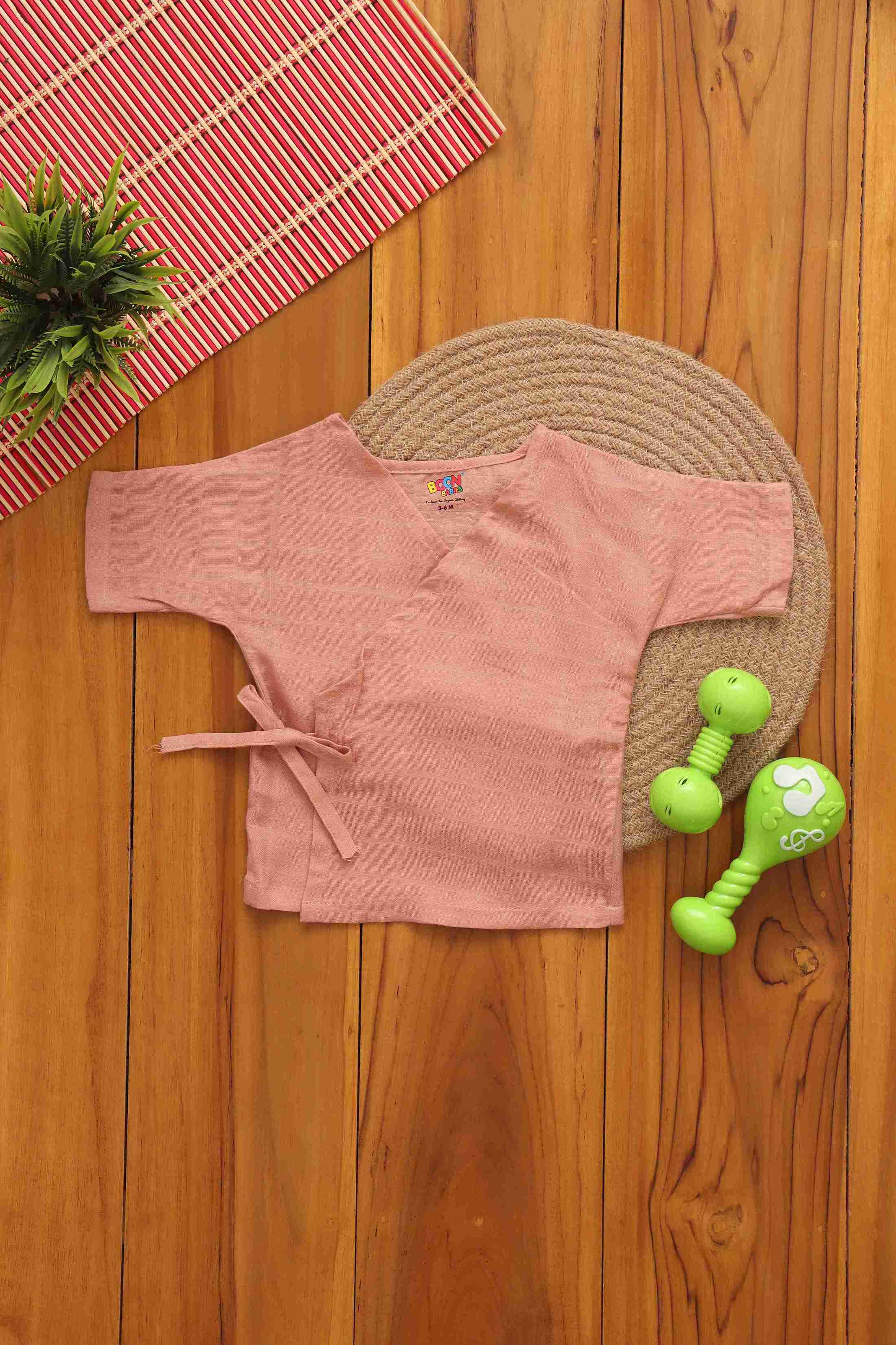 Soft peach baby kimono top by Boon Babies, made of two-layer muslin, featuring a gentle, adorable design for infants.