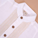 Boys white cotton popcorn shirt with wooden buttons, solid design, by Boon Babies, suitable for ages 6-12 months.