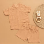 Camel beige boys muslin shirt and shorts set with hippo patch embroidery, Chinese collar, and wooden buttons – breathable summer outfit by Boon Babies.
