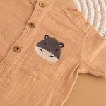 Camel beige boys muslin shirt and shorts set with hippo patch embroidery, Chinese collar, and wooden buttons – breathable summer outfit by Boon Babies.
