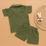 Dark olive green boys shirt and shorts set made of soft crinkled muslin, featuring a giraffe patch and wooden buttons – by Boon Babies in Coimbatore.
