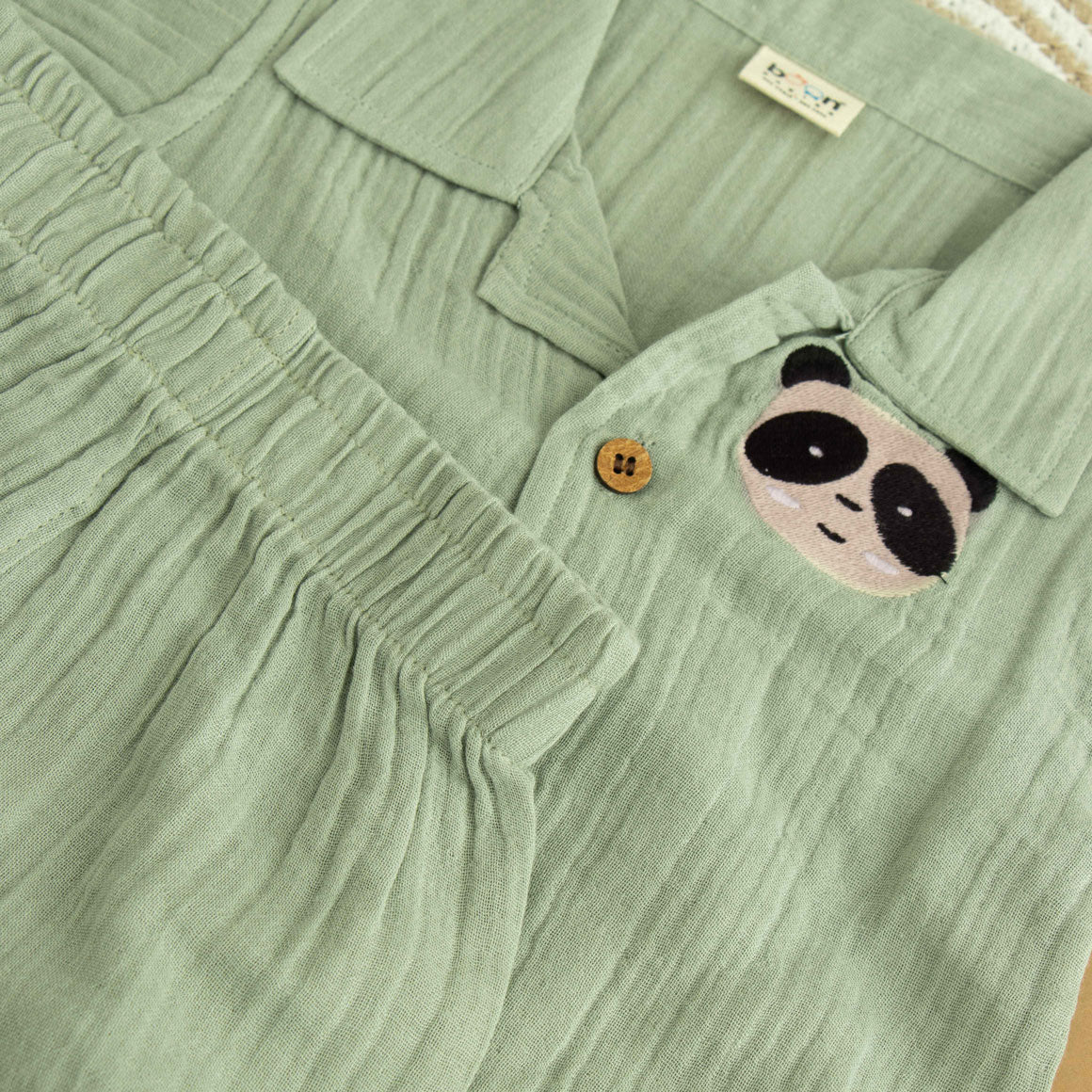 Mint green boys’ shirt and shorts co-ord set in crinkled muslin with panda embroidery and wooden buttons – from Boon Babies kidswear in Coimbatore.
