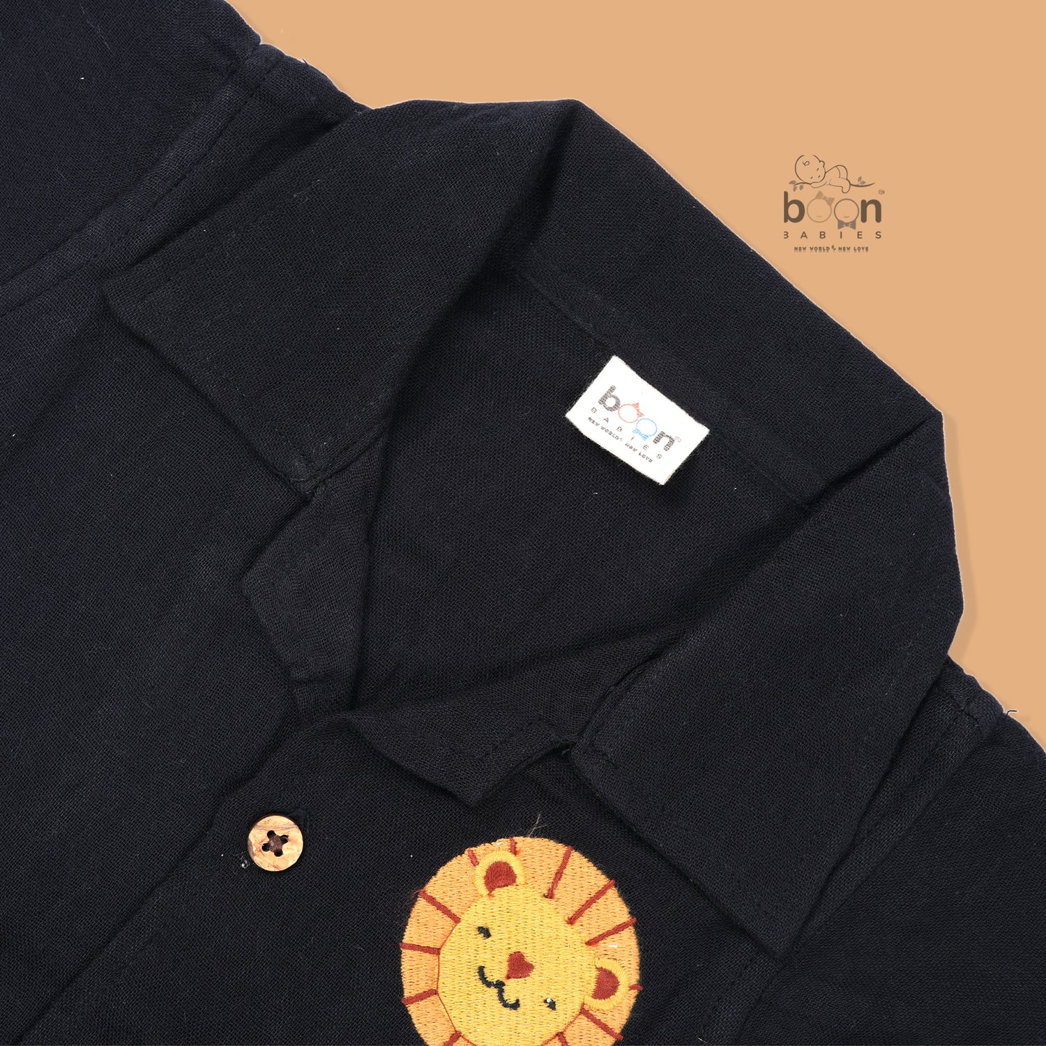 Black crinkle muslin shirt and shorts set for boys featuring lion face embroidery and wooden buttons – breathable toddler outfit by Boon Babies, Coimbatore.

