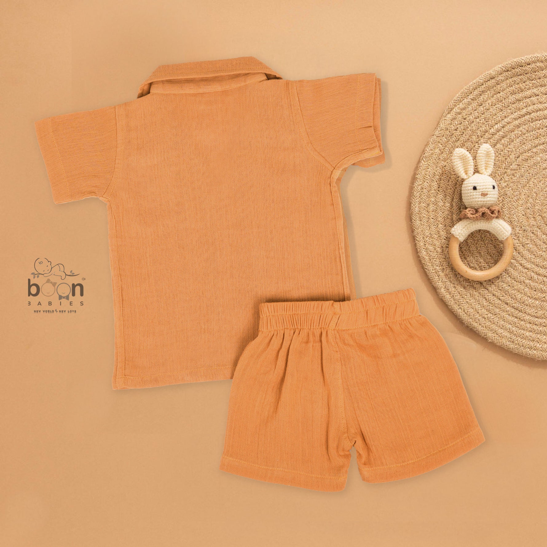 Orange crinkle muslin shirt and shorts set for boys with lion face embroidery, open collar, and elastic shorts – Boon Babies’ breathable summer wear from Coimbatore.
