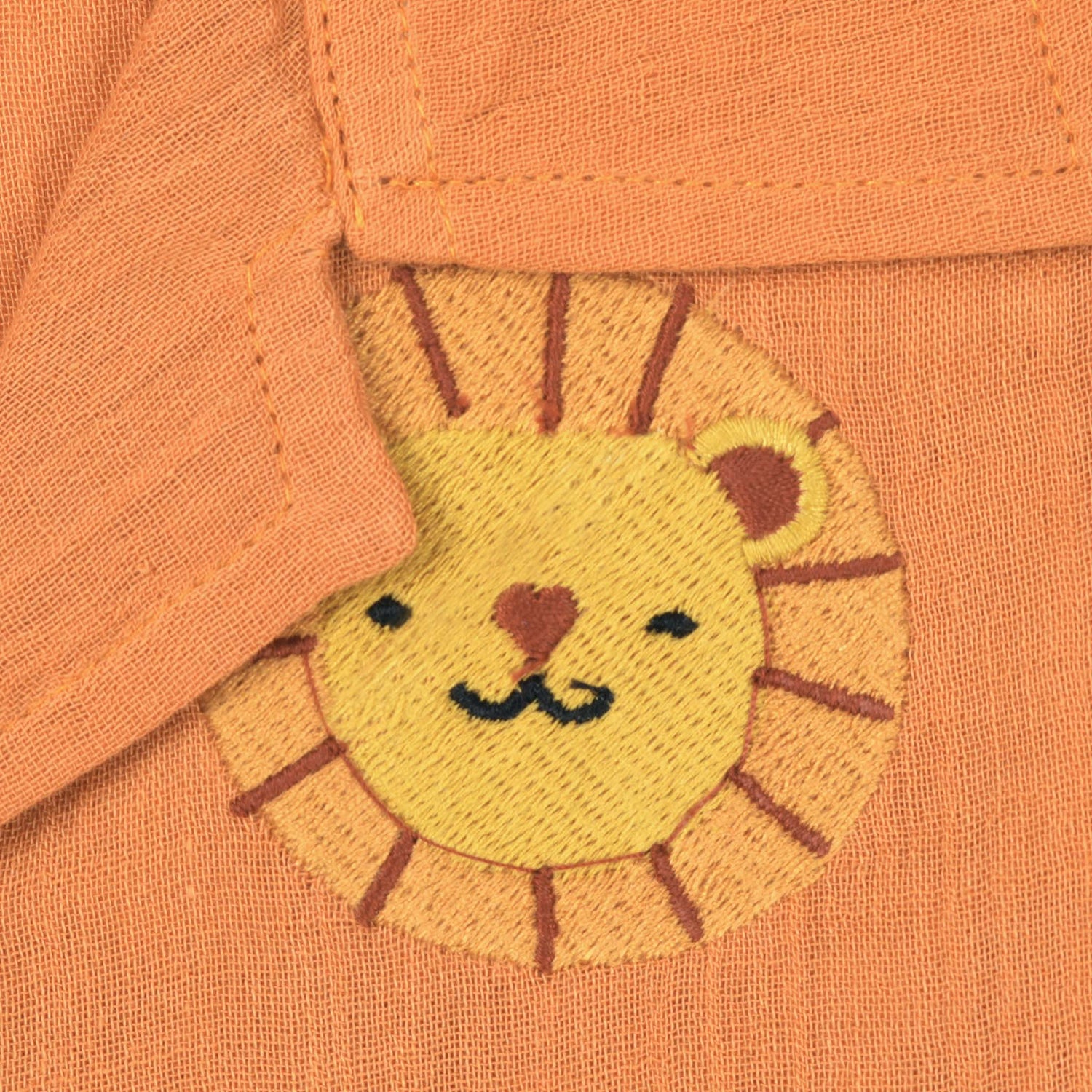 Orange crinkle muslin shirt and shorts set for boys with lion face embroidery, open collar, and elastic shorts – Boon Babies’ breathable summer wear from Coimbatore.
