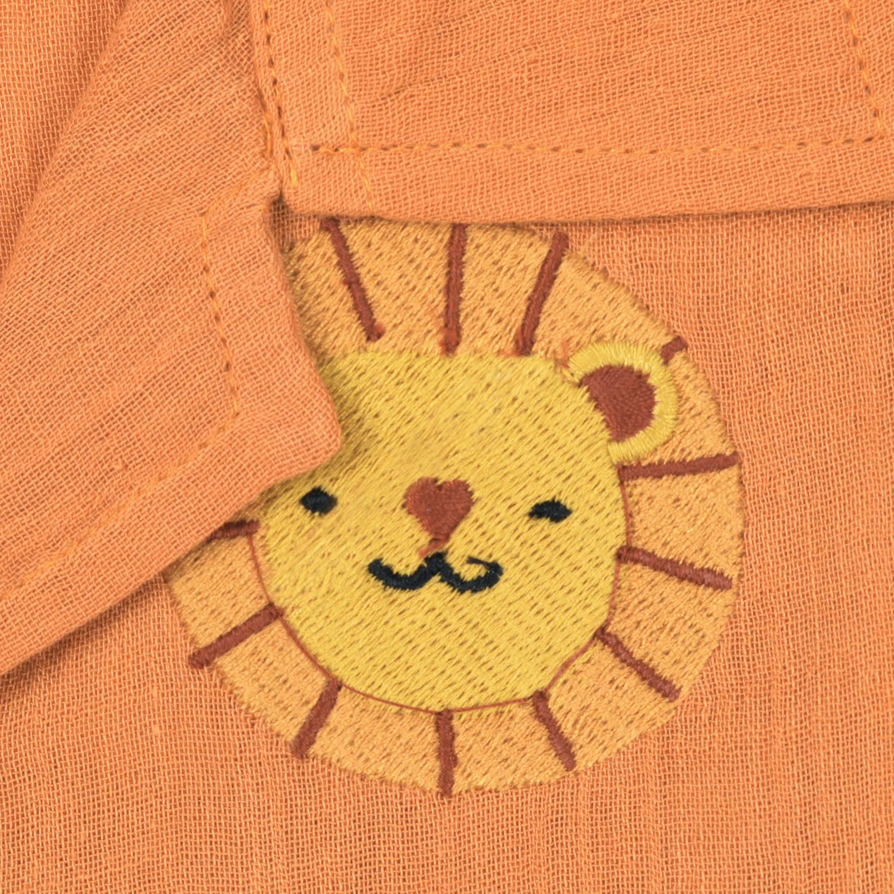 Orange crinkle muslin shirt and shorts set for boys with lion face embroidery, open collar, and elastic shorts – Boon Babies’ breathable summer wear from Coimbatore.
