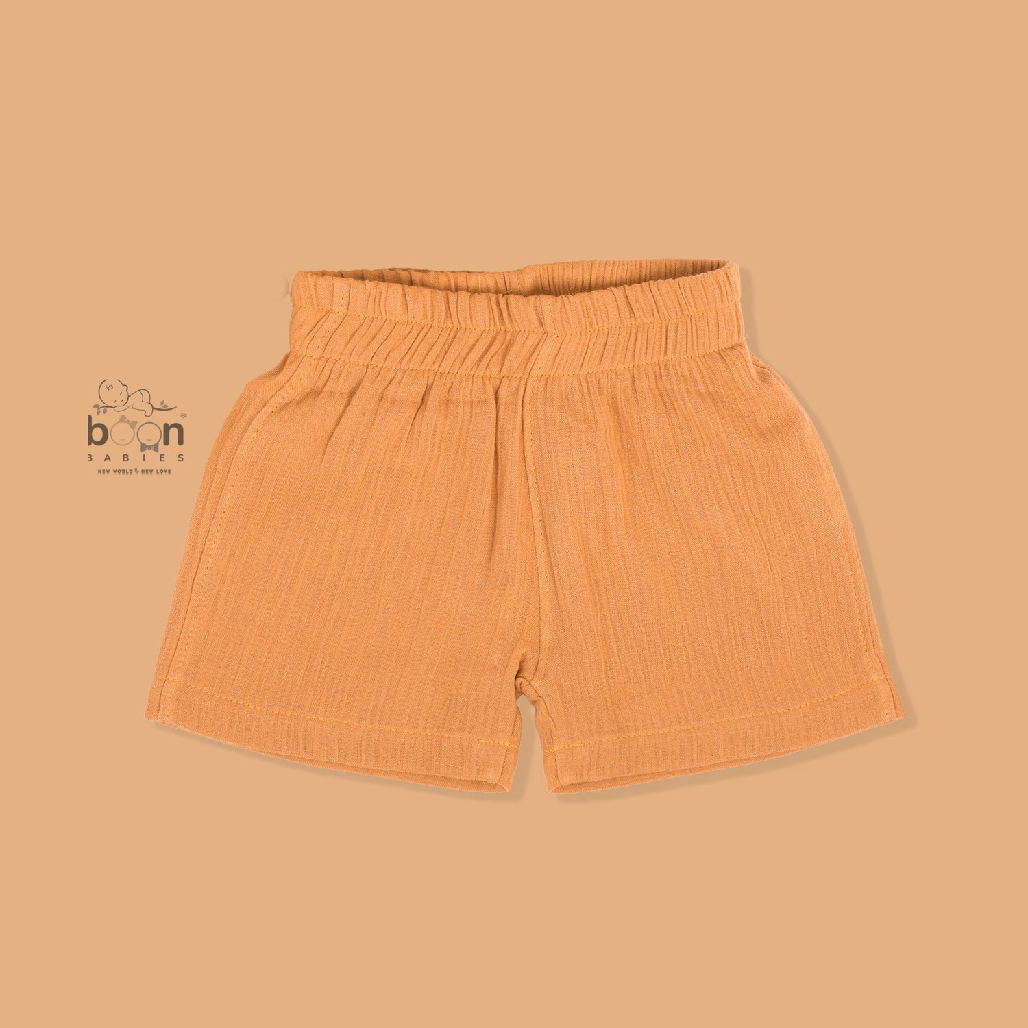 Orange crinkle muslin shirt and shorts set for boys with lion face embroidery, open collar, and elastic shorts – Boon Babies’ breathable summer wear from Coimbatore.

