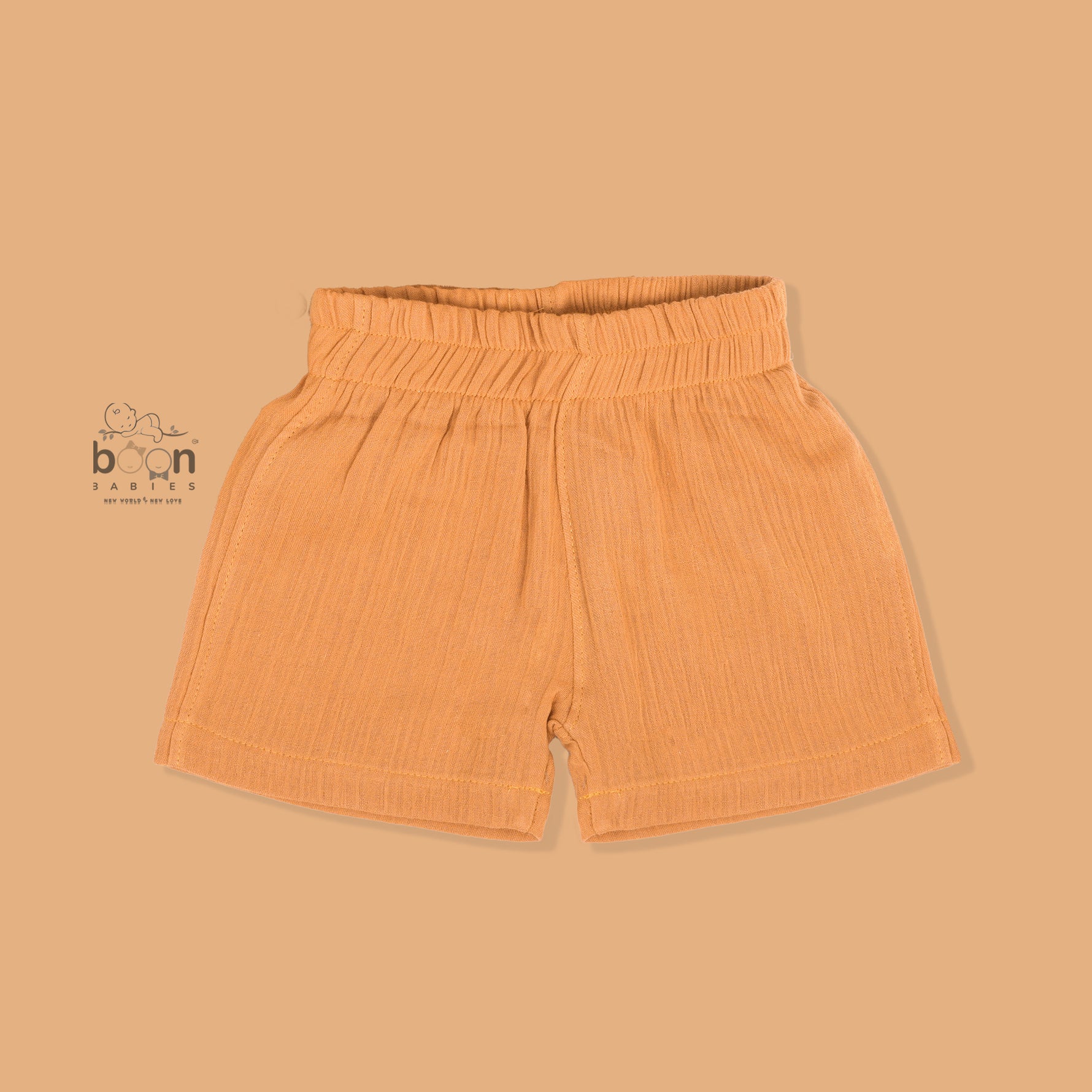 Orange crinkle muslin shirt and shorts set for boys with lion face embroidery, open collar, and elastic shorts – Boon Babies’ breathable summer wear from Coimbatore.
