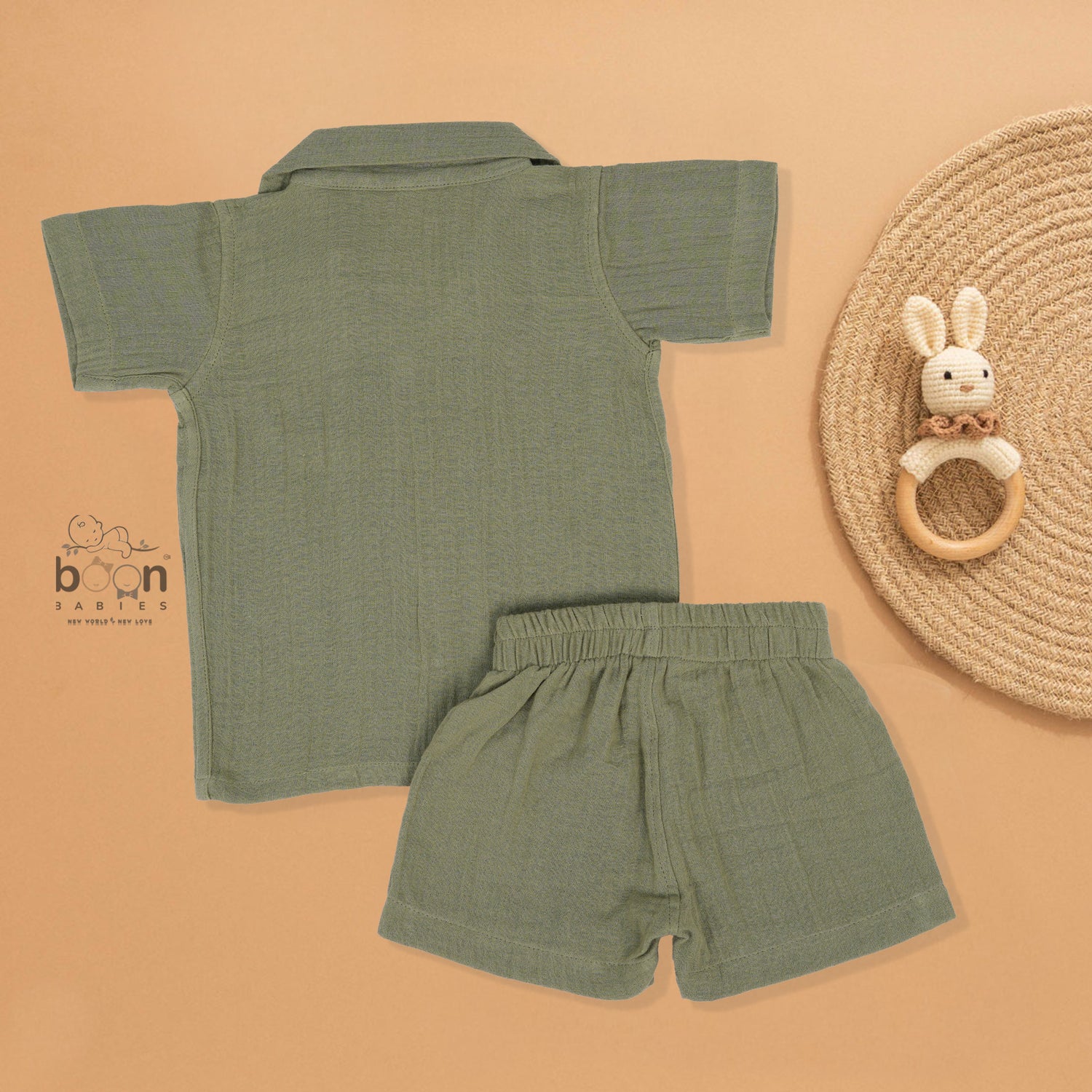Panda face embroidered crinkle muslin shirt and shorts set in earthy green for boys, featuring an open collar and elastic shorts – from Boon Babies, Coimbatore.
