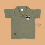 Panda face embroidered crinkle muslin shirt and shorts set in earthy green for boys, featuring an open collar and elastic shorts – from Boon Babies, Coimbatore.
