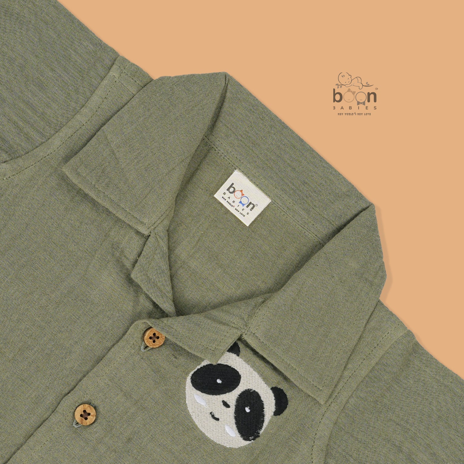 Panda face embroidered crinkle muslin shirt and shorts set in earthy green for boys, featuring an open collar and elastic shorts – from Boon Babies, Coimbatore.
