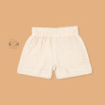 Cream crinkle muslin shirt and shorts set for boys featuring tiger face embroidery, open collar, and elastic shorts – from Boon Babies, Coimbatore.
