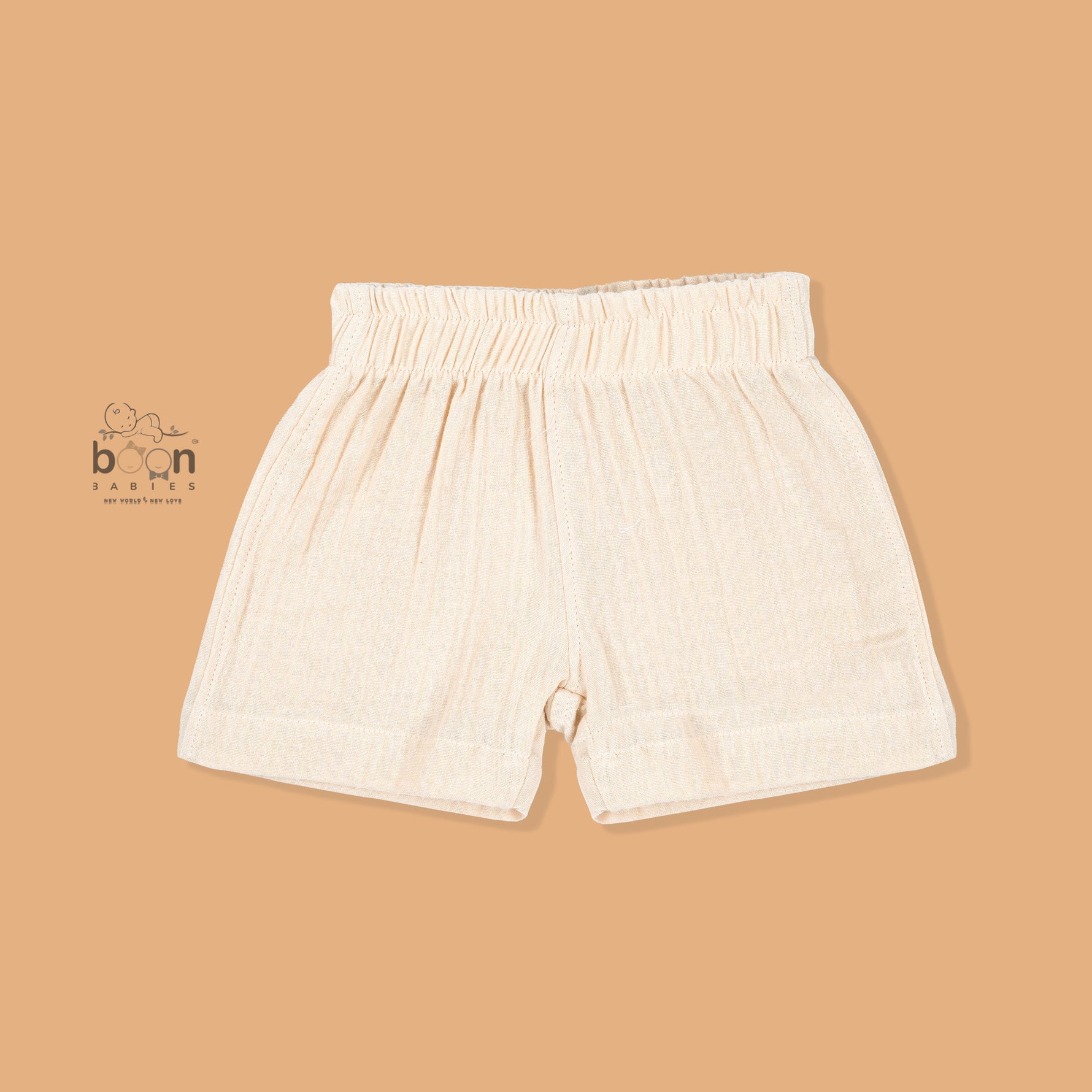 Cream crinkle muslin shirt and shorts set for boys featuring tiger face embroidery, open collar, and elastic shorts – from Boon Babies, Coimbatore.
