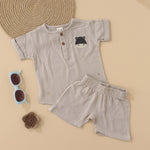 Beige baby boys’ muslin shirt and shorts set with hippo embroidery, made of soft crinkled muslin – Boon Babies eco-friendly summer wear from Coimbatore.
