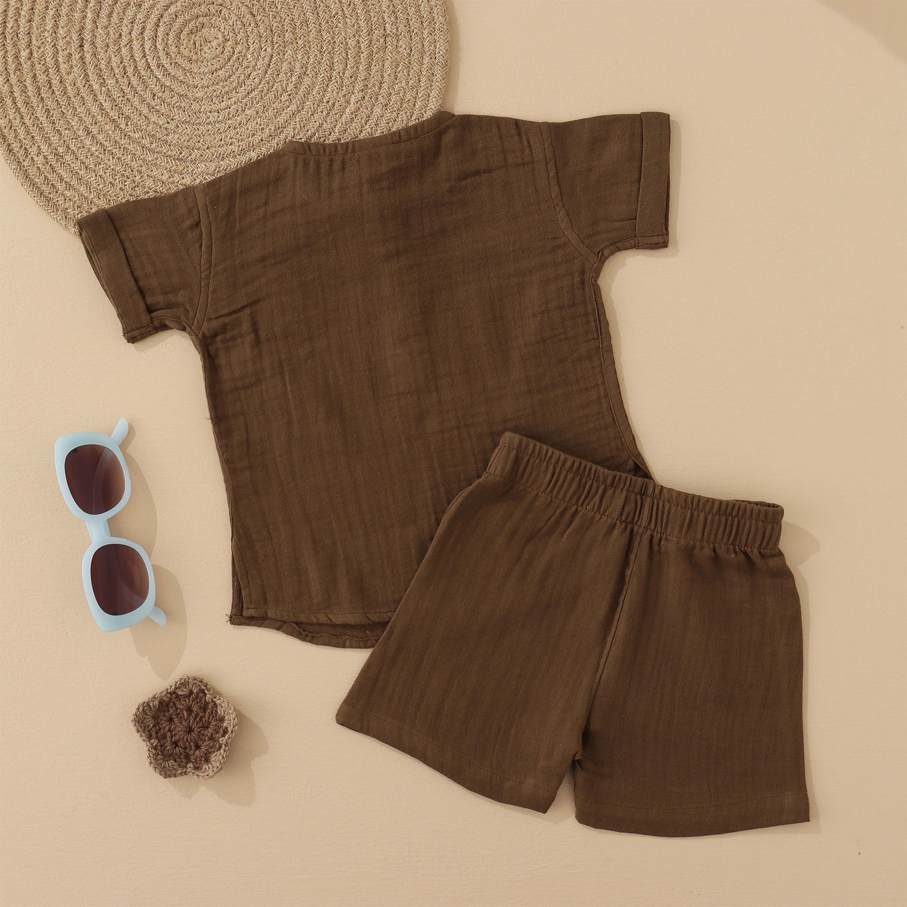 Olive green boys’ muslin shirt and shorts set with tiger face embroidery, wooden buttons, and elastic shorts – soft summer outfit by Boon Babies, Coimbatore.
