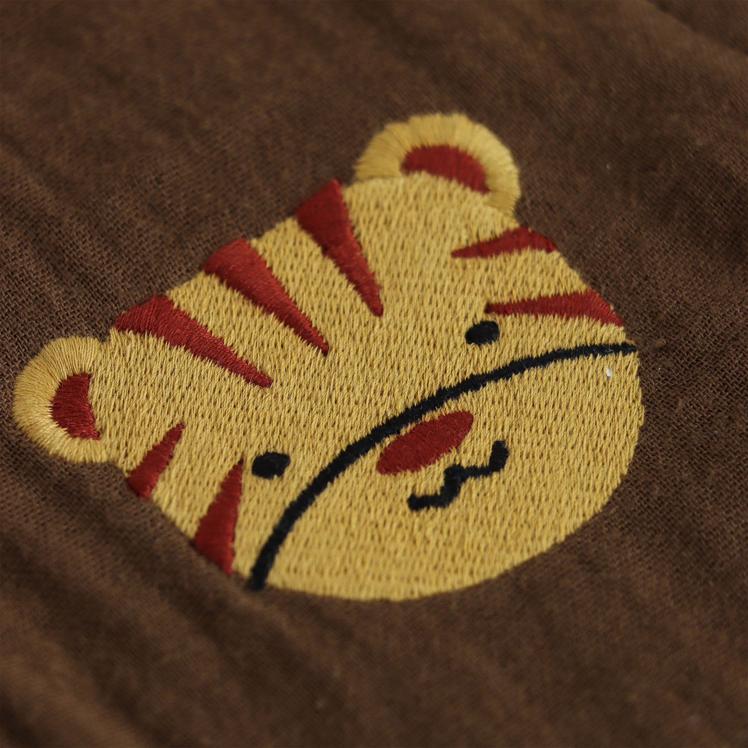 Olive green boys’ muslin shirt and shorts set with tiger face embroidery, wooden buttons, and elastic shorts – soft summer outfit by Boon Babies, Coimbatore.
