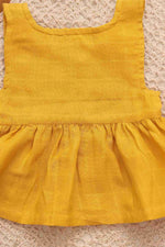 Yellow solid sleeveless baby frock by Boon Babies with four-layer muslin fabric, playful and elegant for little girls.