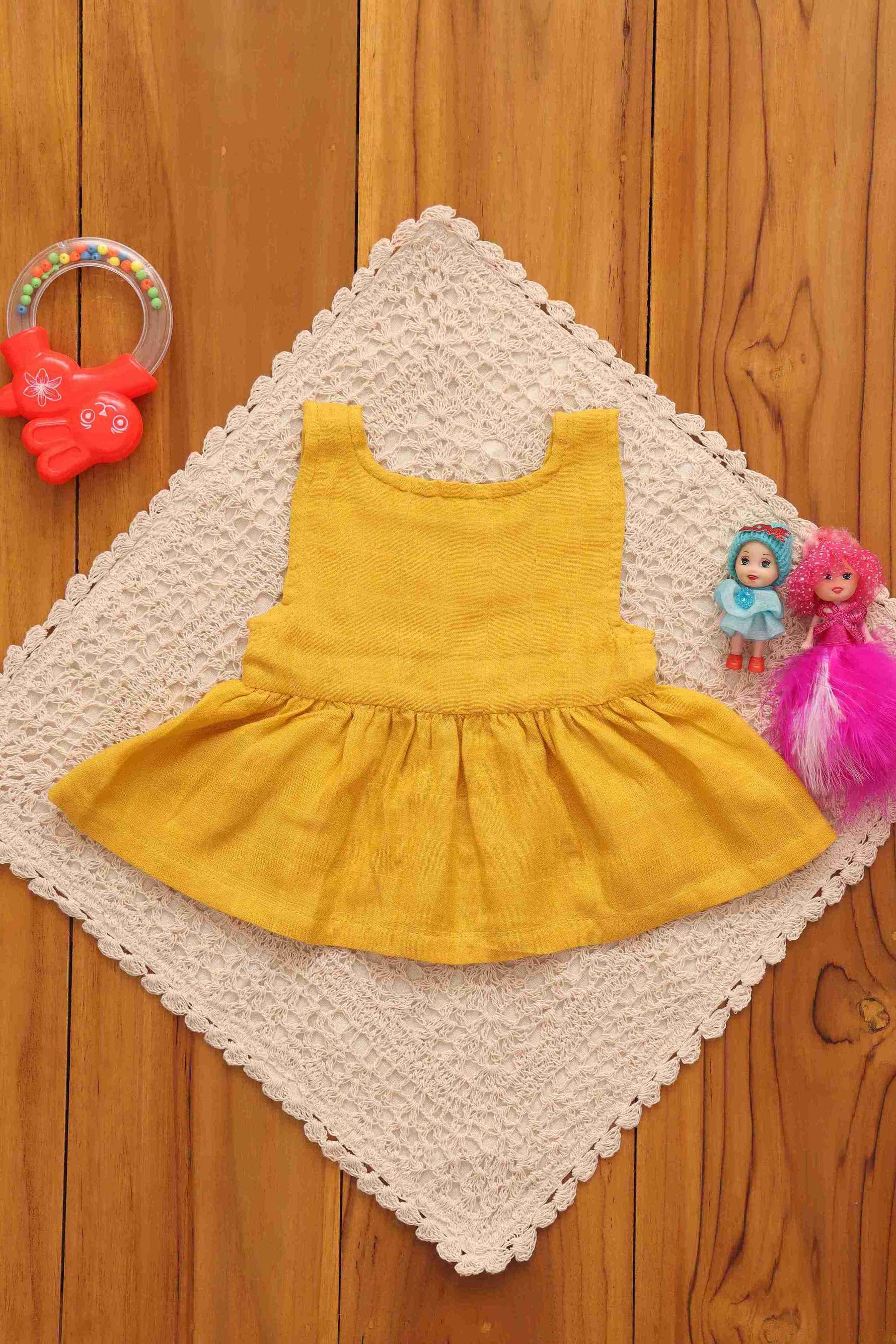 Yellow solid sleeveless baby frock by Boon Babies, made of 4-layer muslin, featuring a playful and elegant design for infants.