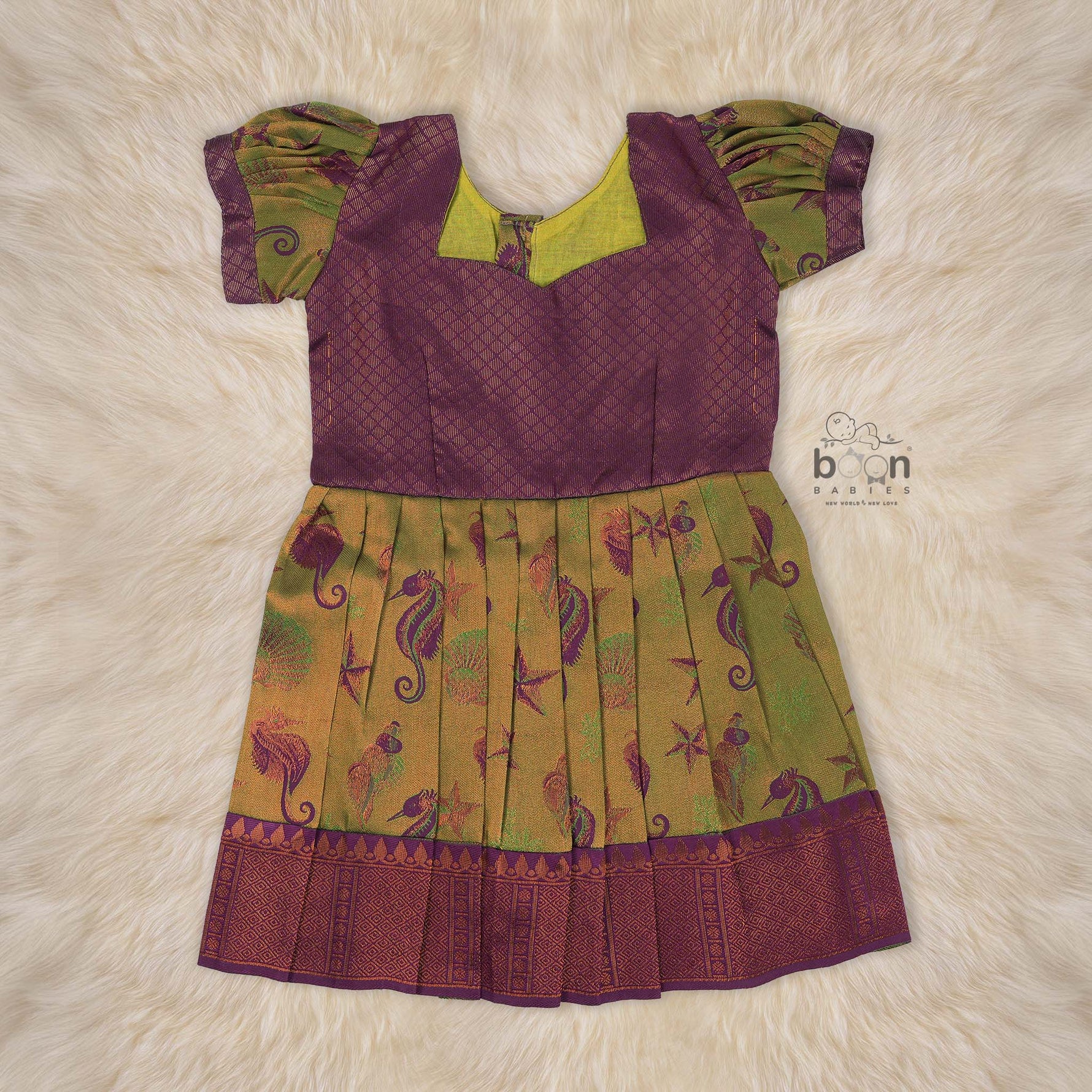 Traditional silk ethnic frock in olive green and maroon with festive motifs, perfect for girls aged 1 to 5 years. Elegant and comfortable for celebrations.
