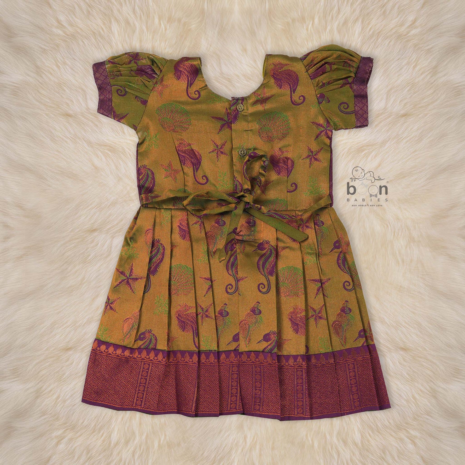 Traditional silk ethnic frock in olive green and maroon with festive motifs, perfect for girls aged 1 to 5 years. Elegant and comfortable for celebrations.