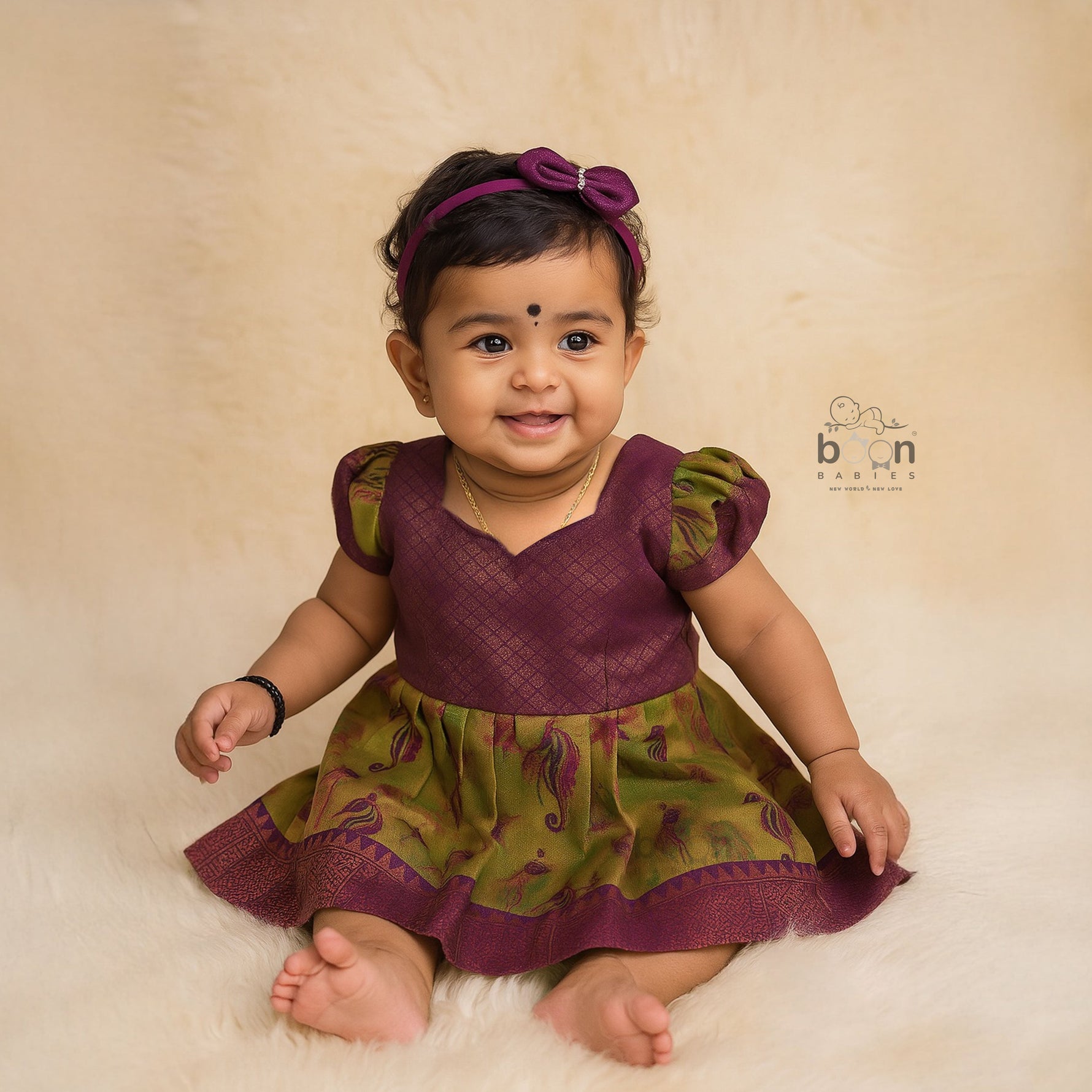 Traditional silk ethnic frock in olive green and maroon with festive motifs, perfect for girls aged 1 to 5 years. Elegant and comfortable for celebrations.
