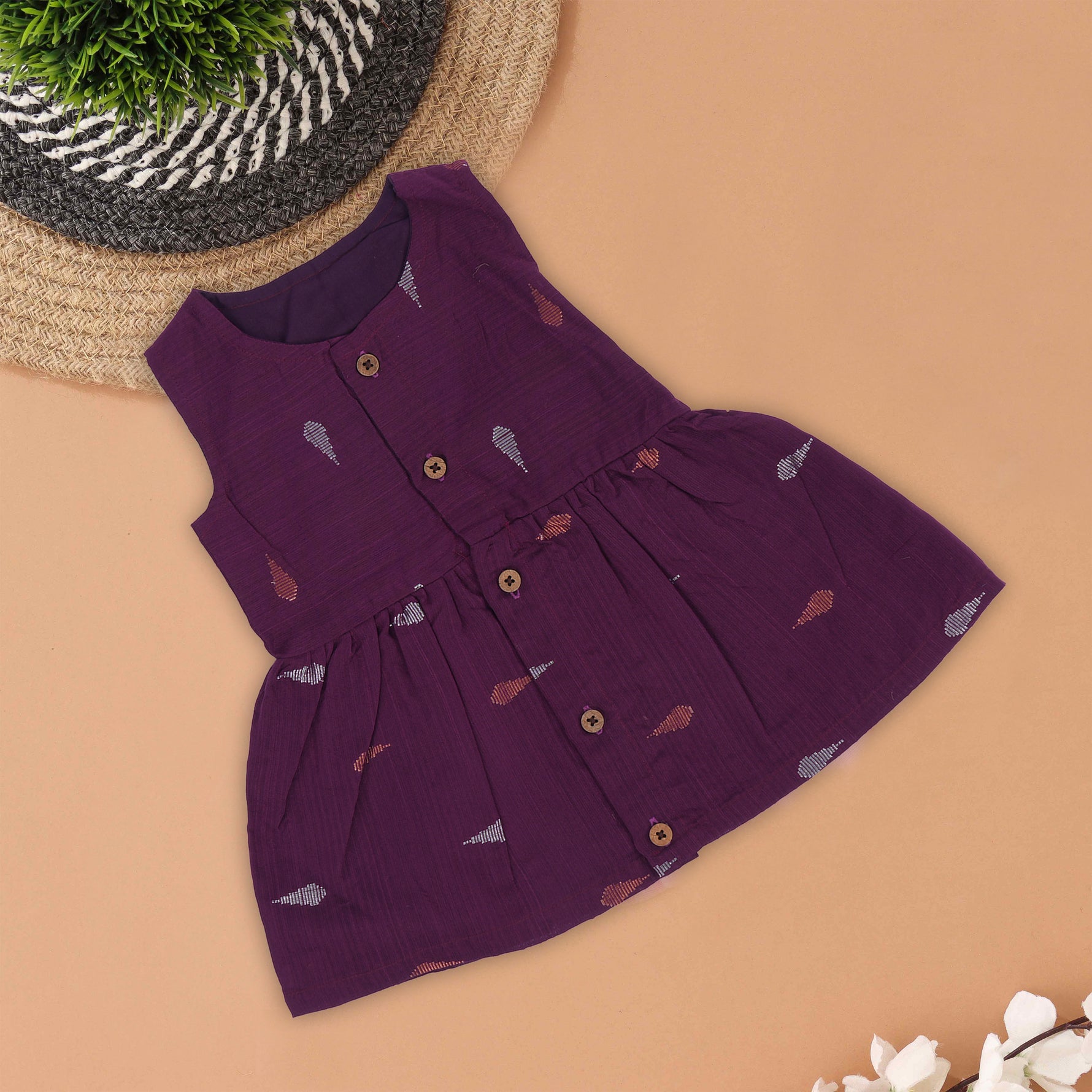 Ethnic purple silk frock for baby girls (3–18 months) with wooden buttons & printed detailing – traditional yet comfortable festive wear.