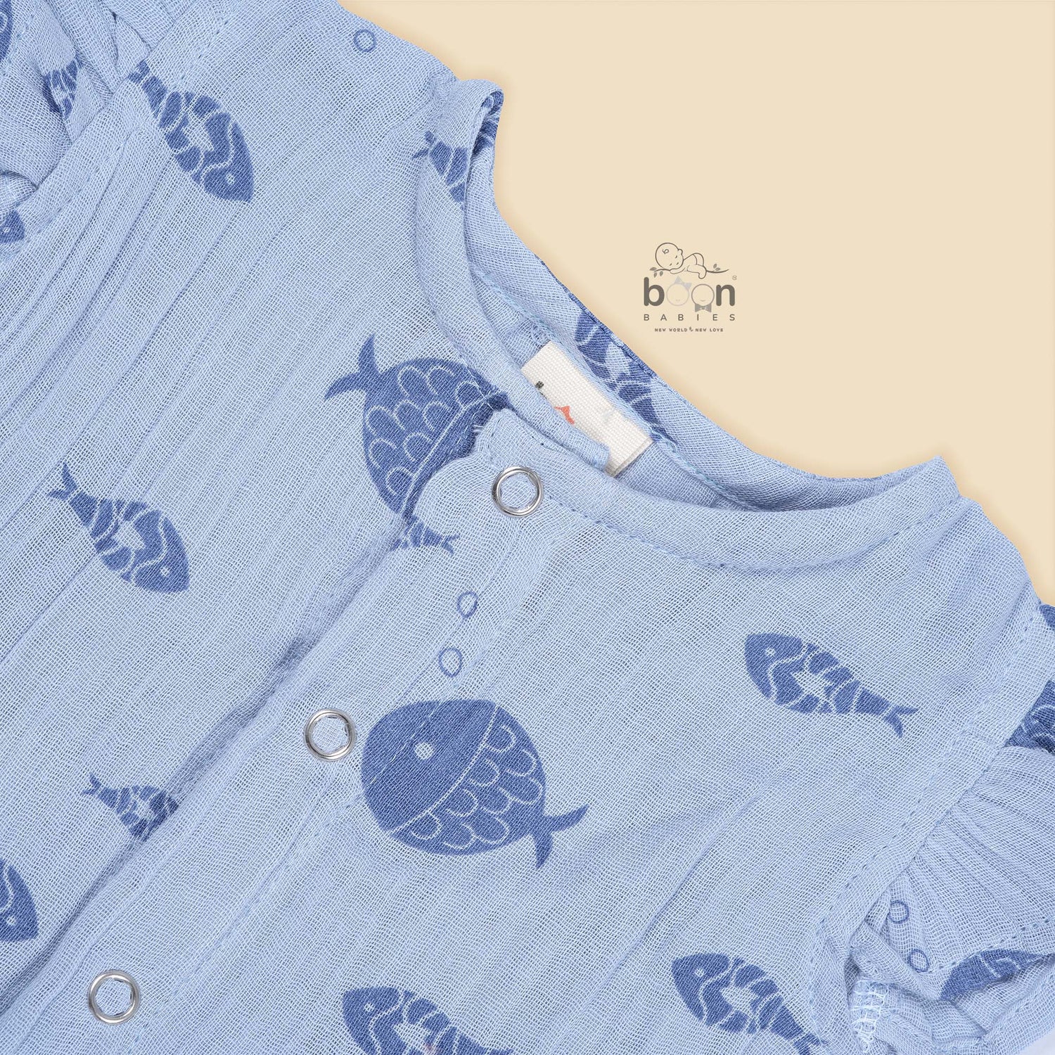 Baby romper in soft blue crinkled muslin with navy fish prints and snap buttons – perfect for 0 to 12 months, from Boon Babies, Coimbatore.