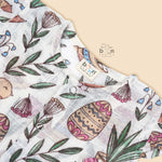 Cotton baby romper with colorful botanical and bird print, flutter sleeves, side bows, and front snap buttons – from Boon Babies, Coimbatore.
