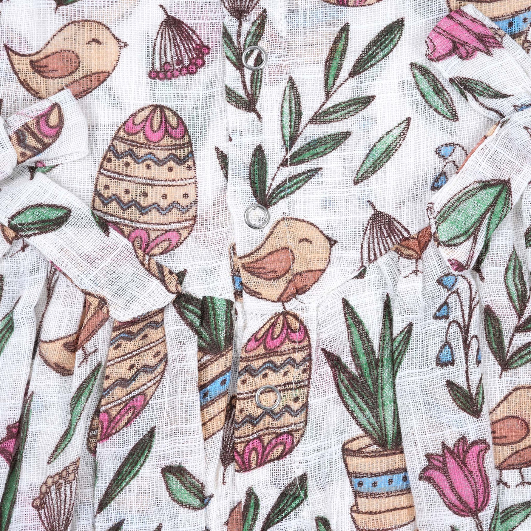 Cotton baby romper with colorful botanical and bird print, flutter sleeves, side bows, and front snap buttons – from Boon Babies, Coimbatore.
