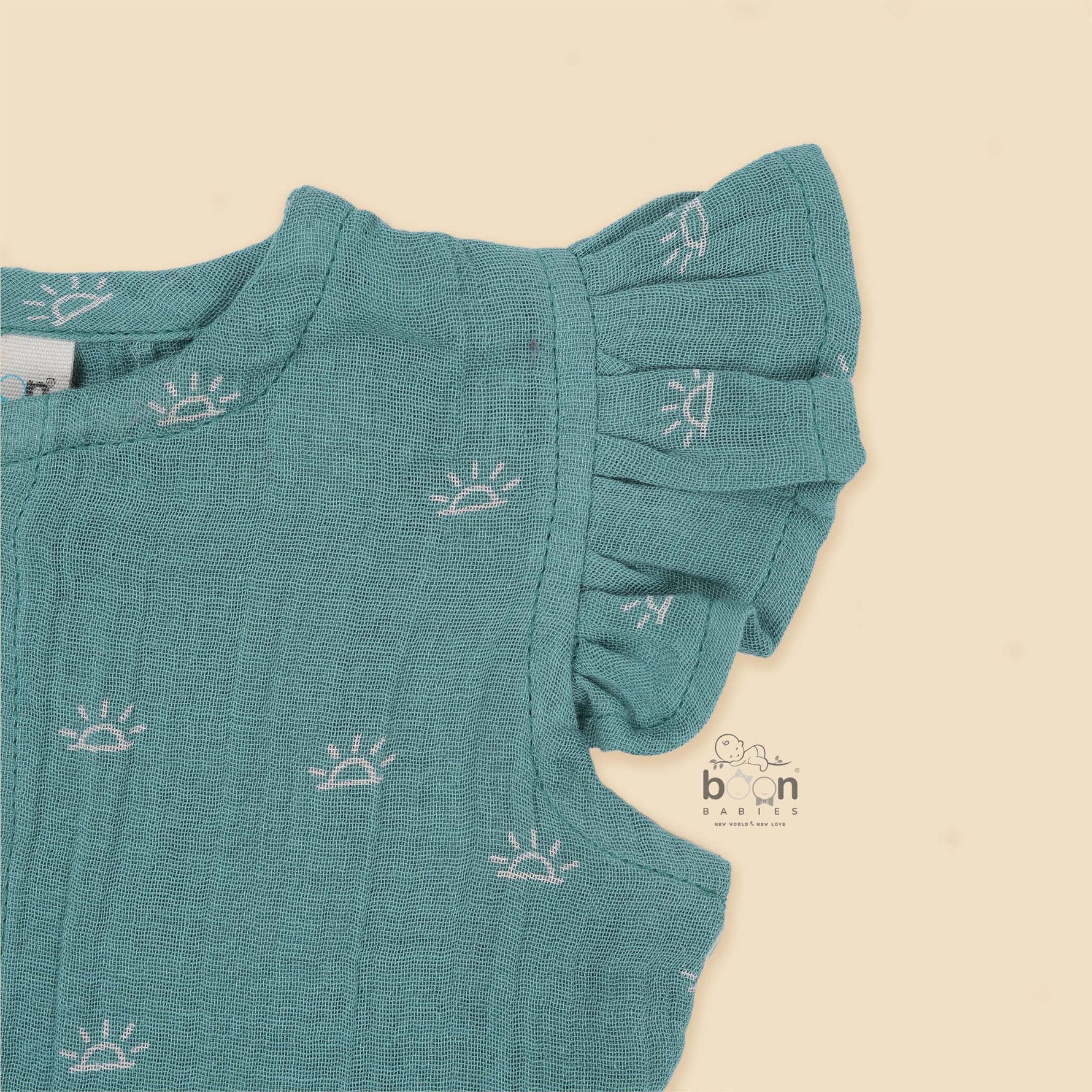 Crinkled muslin baby romper in dusty green with white sun print and flutter sleeves – perfect for 0 to 12 months, from Boon Babies baby cloths collection in Coimbatore.