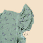 Mint green baby romper in crinkled muslin with leafy print and flutter sleeves, designed for newborns aged 0 to 12 months – Boon Babies Coimbatore collection.