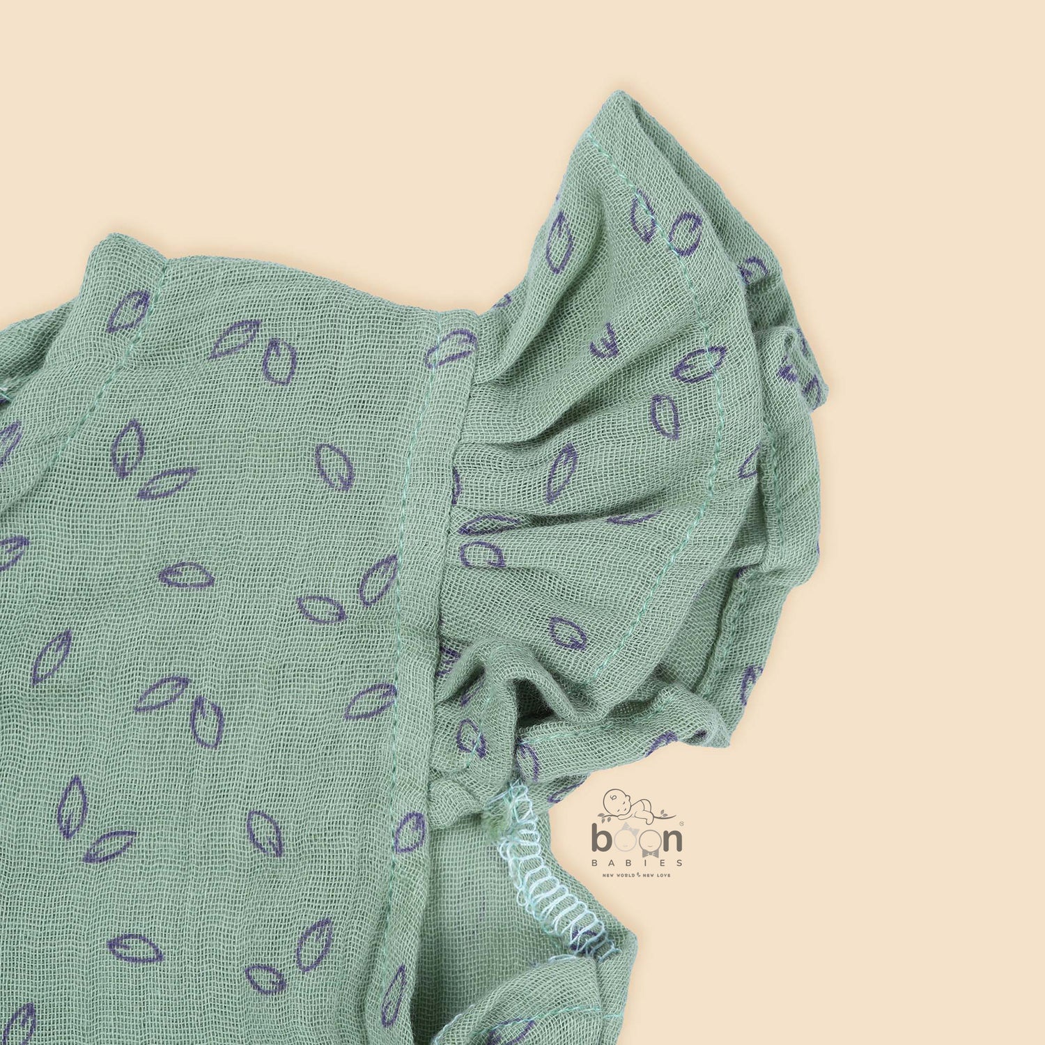 Mint green baby romper in crinkled muslin with leafy print and flutter sleeves, designed for newborns aged 0 to 12 months – Boon Babies Coimbatore collection.