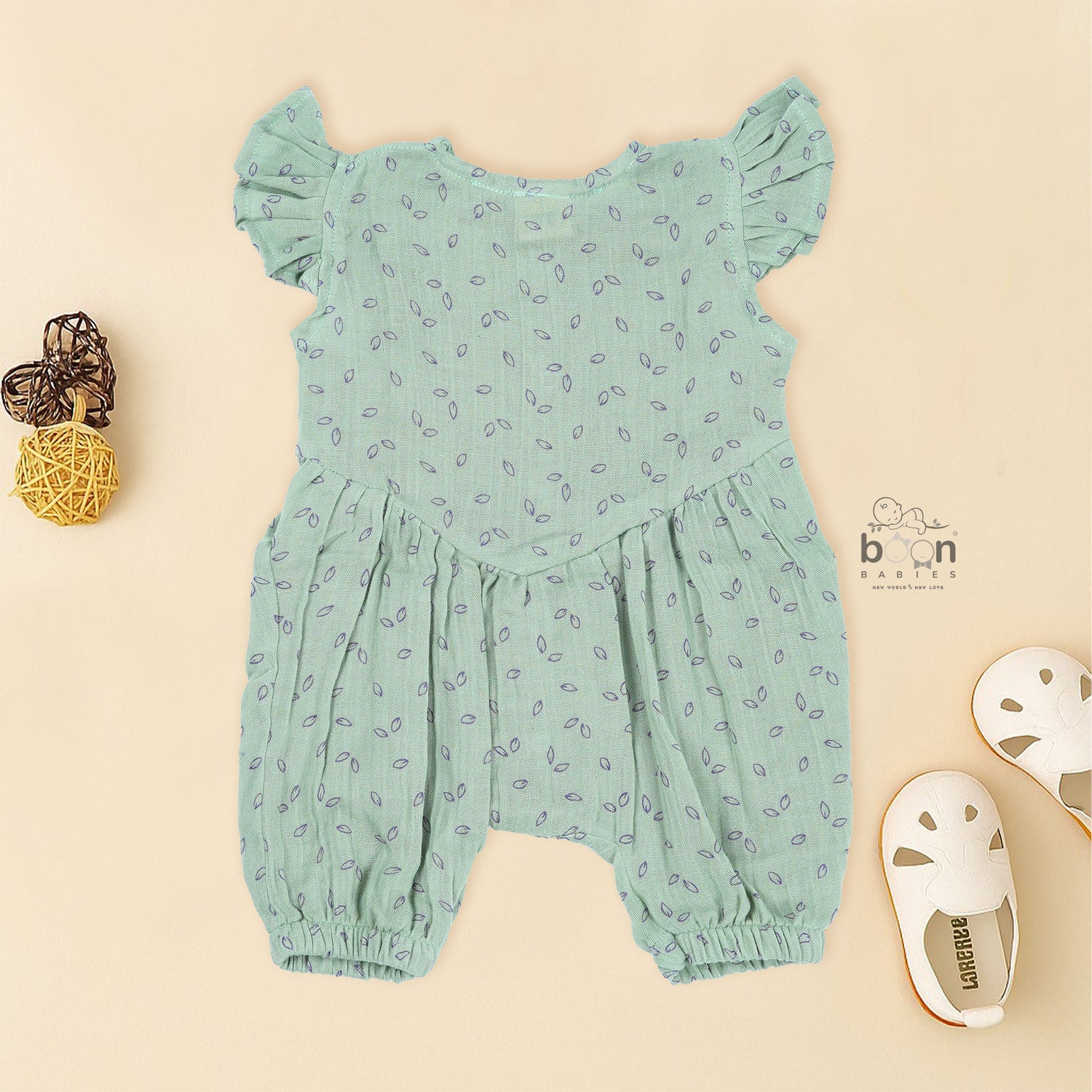 Mint green baby romper in crinkled muslin with leafy print and flutter sleeves, designed for newborns aged 0 to 12 months – Boon Babies Coimbatore collection.