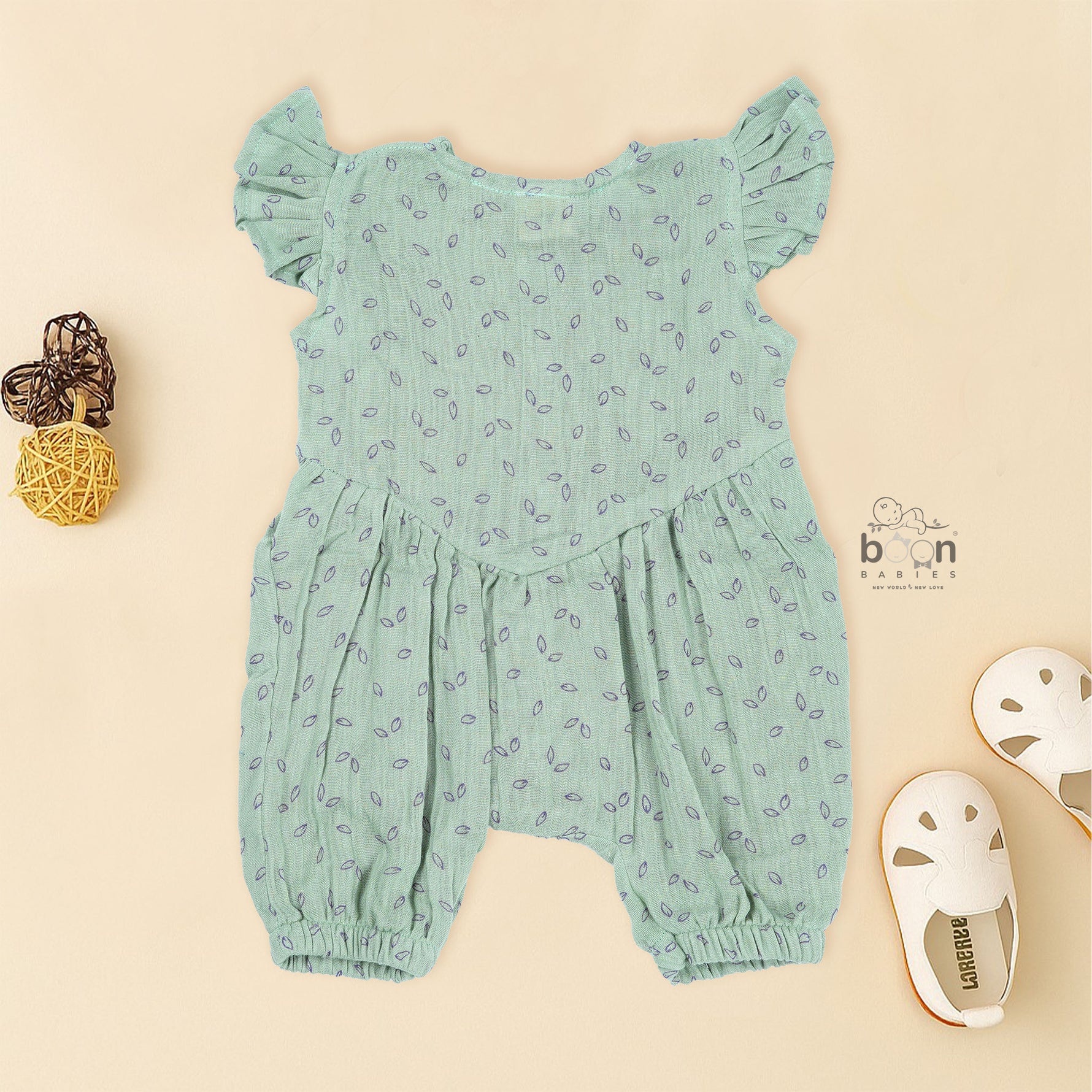 Mint green baby romper in crinkled muslin with leafy print and flutter sleeves, designed for newborns aged 0 to 12 months – Boon Babies Coimbatore collection.
