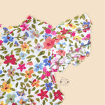 Baby girl romper in soft crinkled muslin with multicolor floral print, flutter sleeves, and side bows – ideal for babies aged 0–12 months by Boon Babies, Coimbatore.