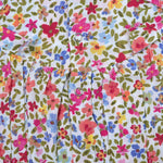 Baby girl romper in soft crinkled muslin with multicolor floral print, flutter sleeves, and side bows – ideal for babies aged 0–12 months by Boon Babies, Coimbatore.