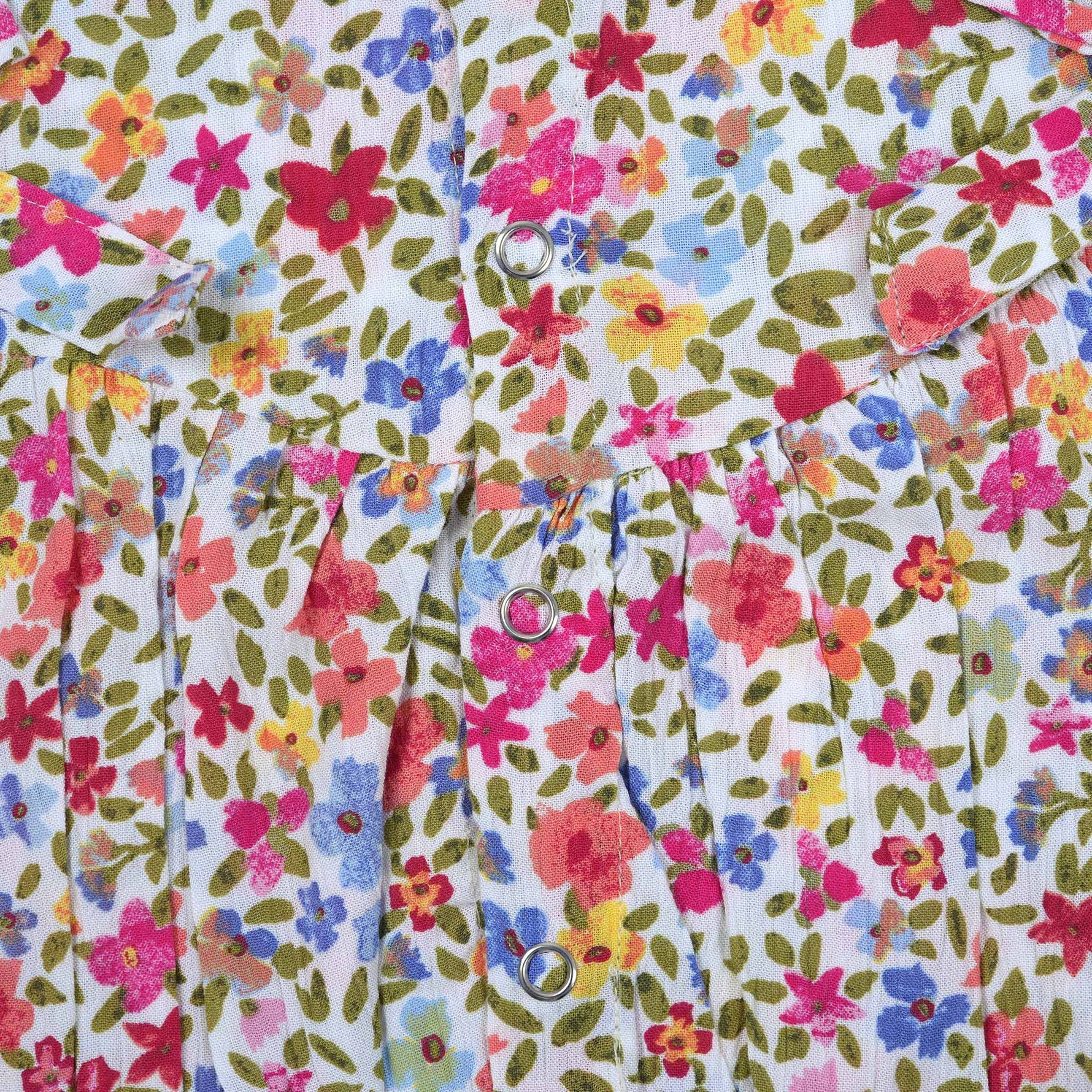 Baby girl romper in soft crinkled muslin with multicolor floral print, flutter sleeves, and side bows – ideal for babies aged 0–12 months by Boon Babies, Coimbatore.