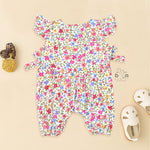 Baby girl romper in soft crinkled muslin with multicolor floral print, flutter sleeves, and side bows – ideal for babies aged 0–12 months by Boon Babies, Coimbatore.