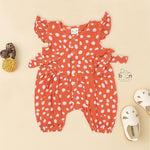 Rust orange baby romper with white polka dots, flutter sleeves, and side bows – made from soft crinkled muslin for babies aged 0–12 months by Boon Babies, Coimbatore.