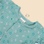 Teal blue baby romper with white floral prints, flutter sleeves, and side bows made from breathable crinkled muslin – designed for babies aged 0–12 months by Boon Babies, Coimbatore.