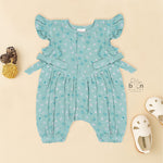 Teal blue baby romper with white floral prints, flutter sleeves, and side bows made from breathable crinkled muslin – designed for babies aged 0–12 months by Boon Babies, Coimbatore.