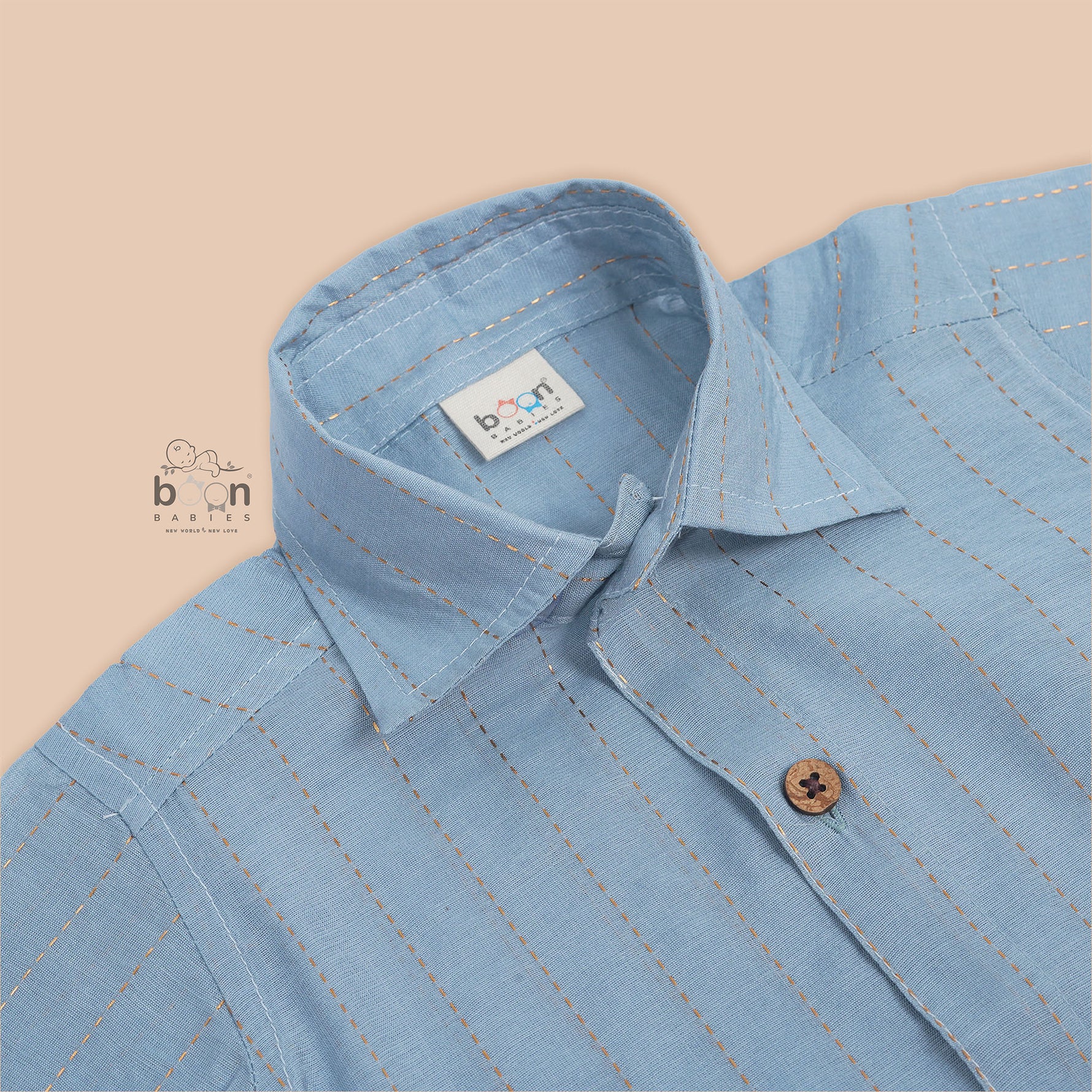 Light blue silk shirt for boys with subtle vertical gold detailing and wooden buttons – traditional festive wear by Boon Babies.

