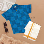 Blue checked silk shirt with Chinese collar and white dhoti with gold border – boys traditional outfit from Boon Babies, styled flatlay.
