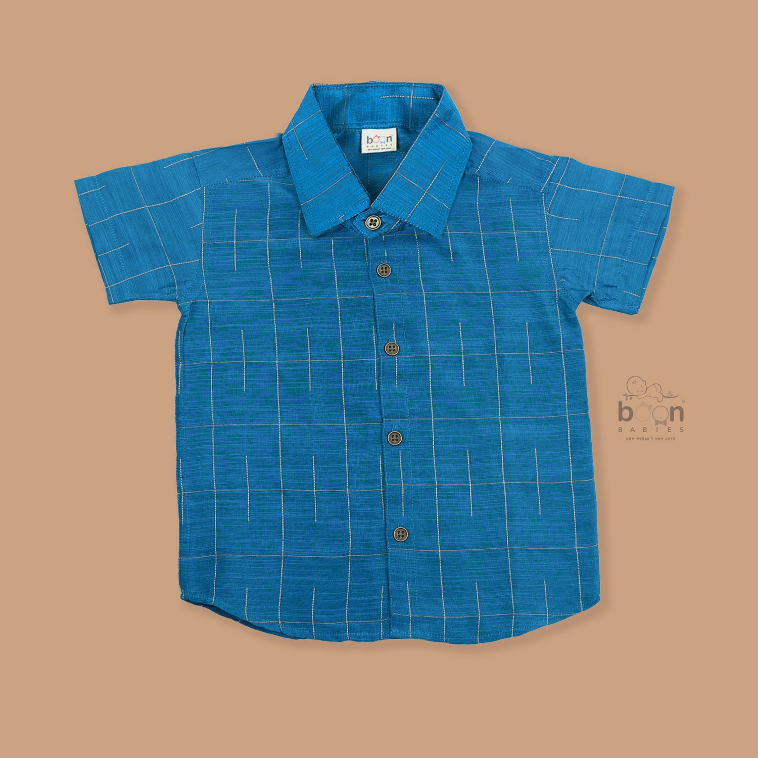 Boys festive outfit featuring a royal blue checked silk shirt and white dhoti with gold border – traditional South Indian attire by Boon Babies.
