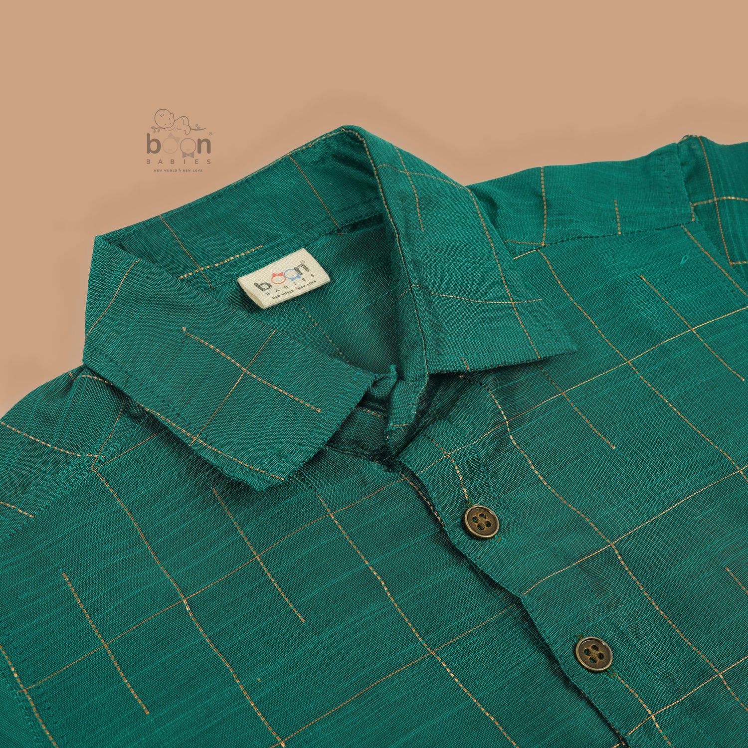 Green silk checked shirt with white dhoti featuring golden border – traditional South Indian boys ethnic wear set by Boon Babies.
