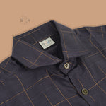 Boys ethnic silk shirt in navy with checked pattern paired with white and gold bordered dhoti, displayed flatlay style – festive wear from Boon Babies.
